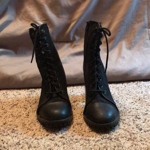 Black heeled combat boot.